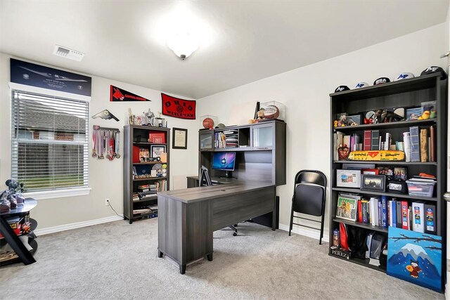 home office featuring light carpet, baseboards, and visible vents