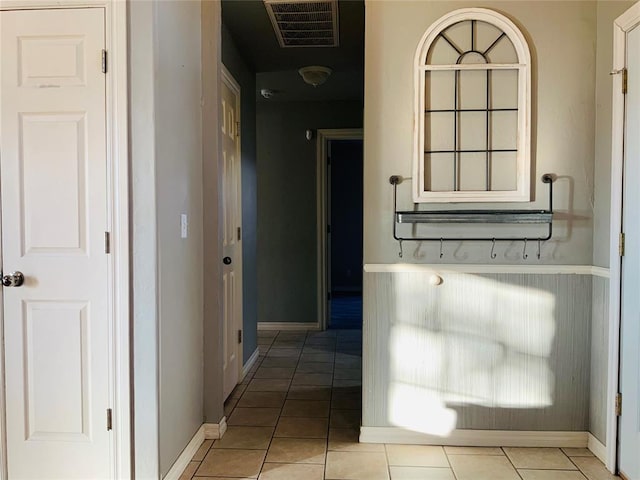 hall featuring light tile patterned floors