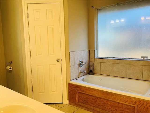 bathroom with a tub to relax in, tile patterned floors, and vanity