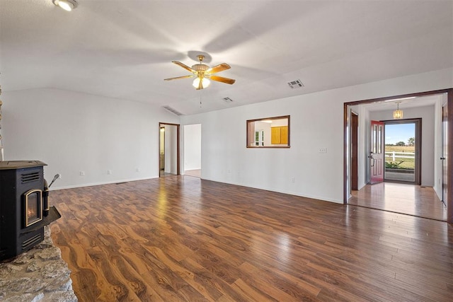 living room featuring dark hardwood / wood-style floors, a wood stove, ceiling fan, and lofted ceiling