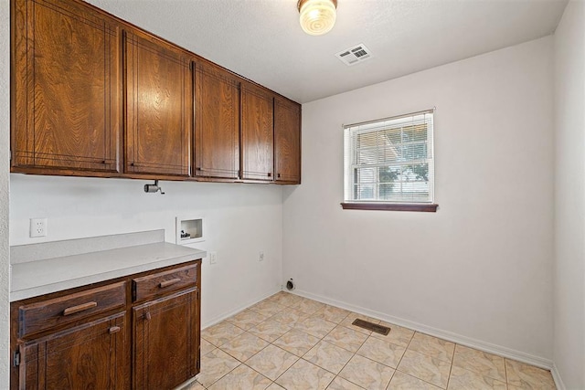 clothes washing area with cabinets, hookup for a washing machine, light tile patterned floors, and electric dryer hookup