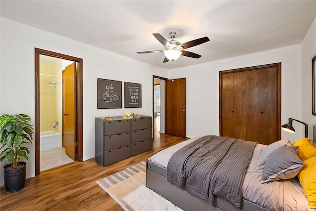 bedroom featuring ensuite bathroom, ceiling fan, and wood-type flooring