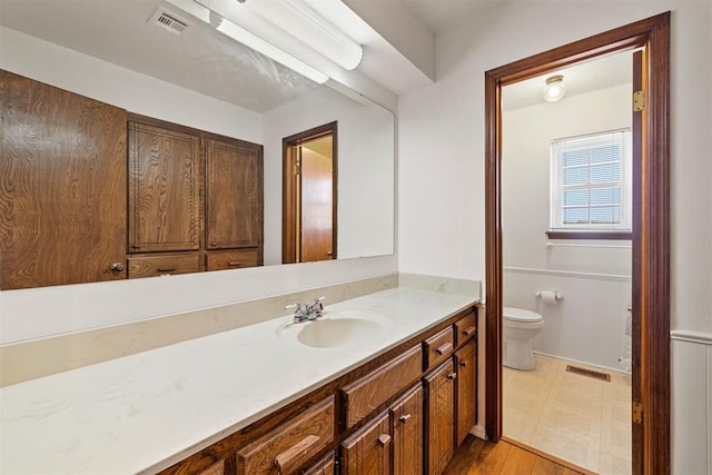 bathroom with vanity and toilet