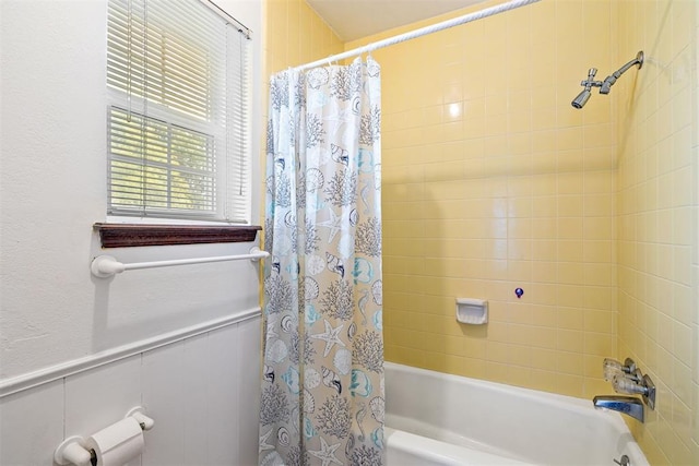 bathroom with shower / bath combo with shower curtain