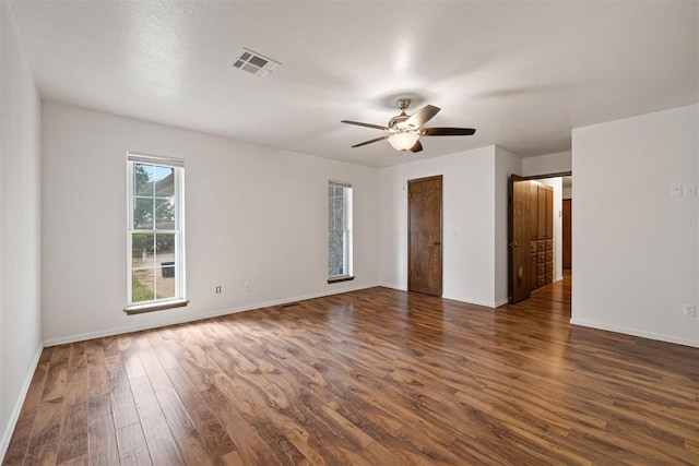 spare room featuring dark hardwood / wood-style floors and ceiling fan