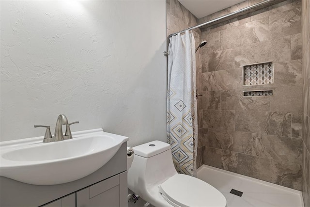 bathroom featuring a shower with curtain, toilet, and vanity