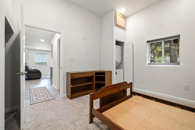 bedroom with light carpet and multiple windows