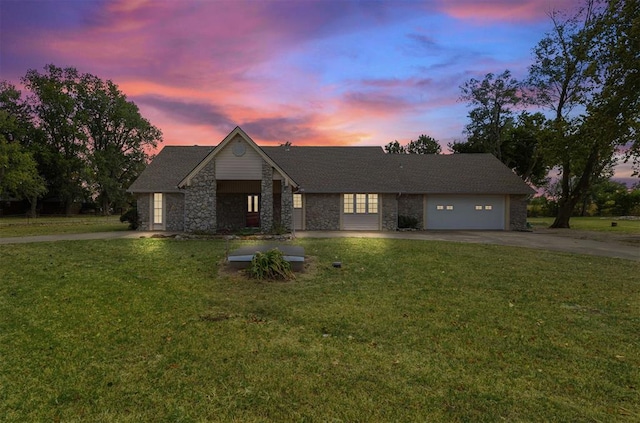 view of front of property with a garage and a yard