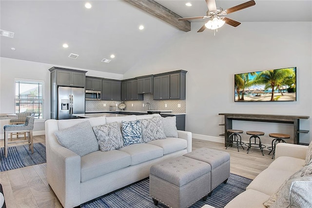 living room with sink, high vaulted ceiling, light hardwood / wood-style flooring, ceiling fan, and beam ceiling