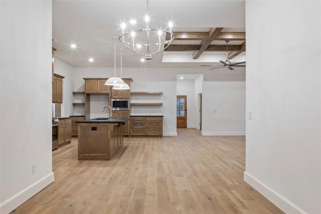 kitchen featuring stainless steel appliances, an island with sink, coffered ceiling, and decorative light fixtures