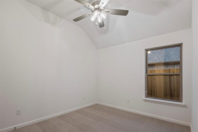 empty room with ceiling fan, lofted ceiling, and carpet flooring