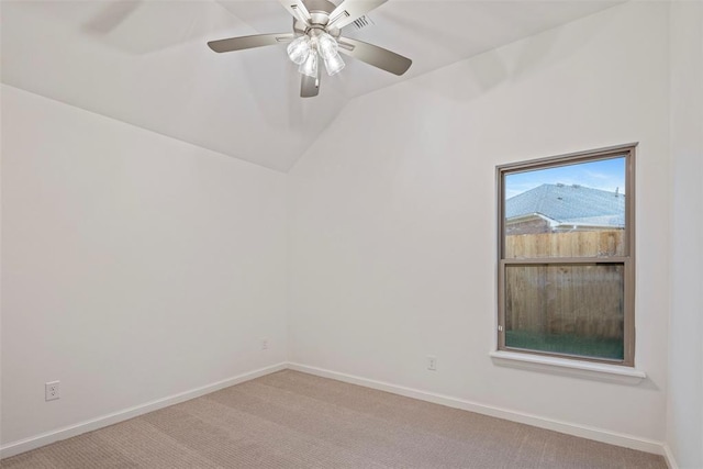 carpeted empty room with vaulted ceiling and ceiling fan