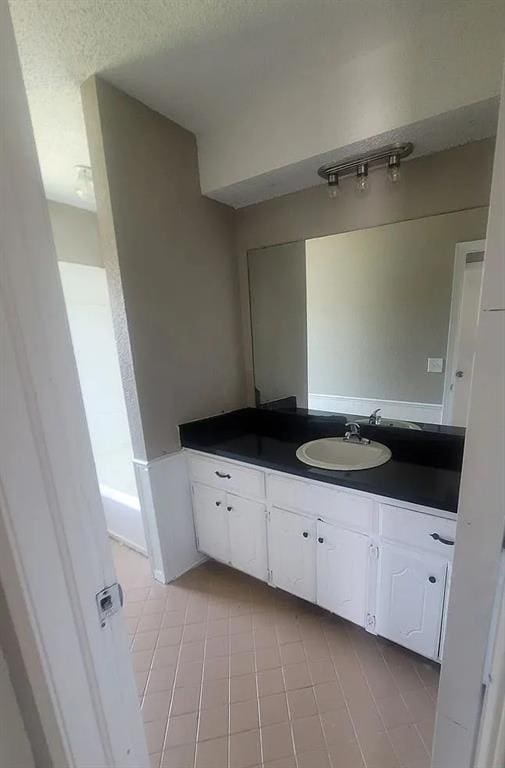 bathroom with tile patterned flooring and vanity