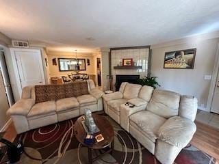 living room with a fireplace and wood-type flooring