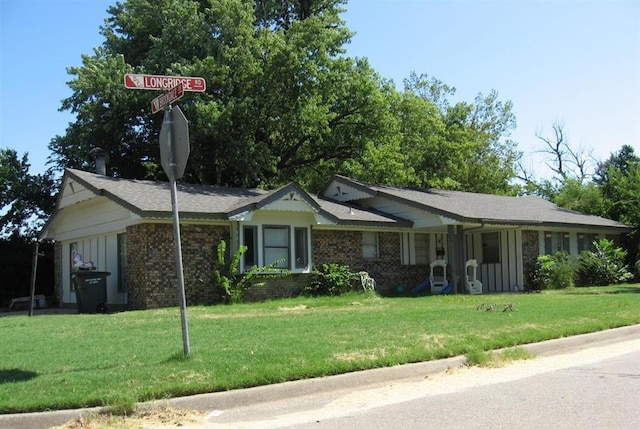 ranch-style home featuring a garage and a front lawn