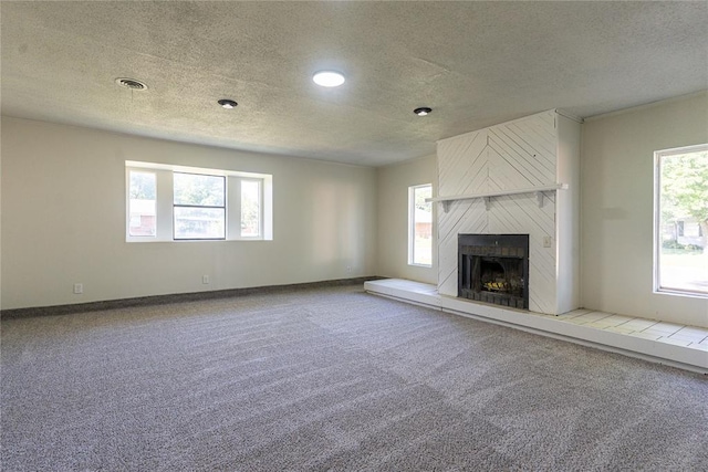 3201 Longridge Rd, Del City, OK 73115 - unfurnished living room featuring carpet floors, a textured ceiling, and a high end fireplace