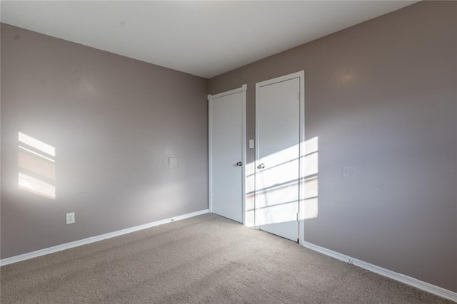 spare room featuring light colored carpet