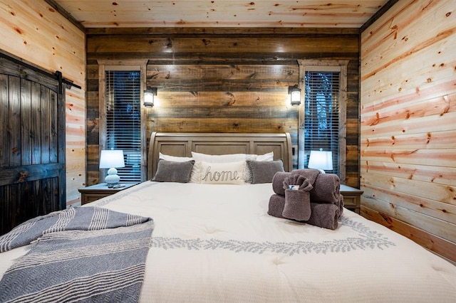 bedroom with wooden ceiling, a barn door, and wooden walls