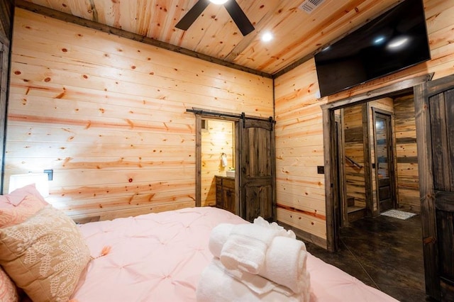 bedroom with ceiling fan, a barn door, wood walls, and wooden ceiling