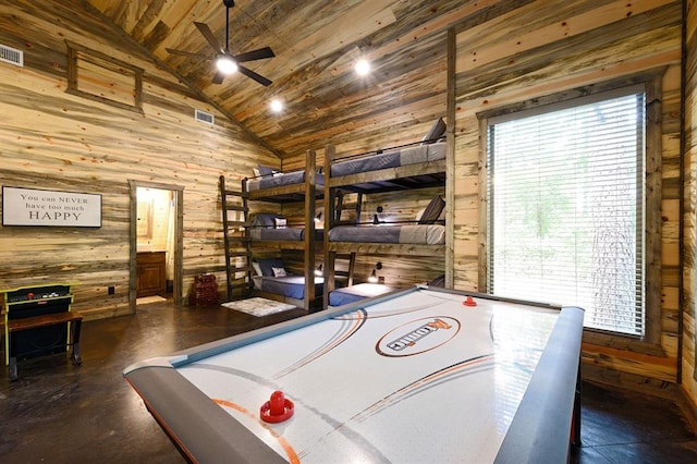 game room with vaulted ceiling, ceiling fan, wood ceiling, and wooden walls