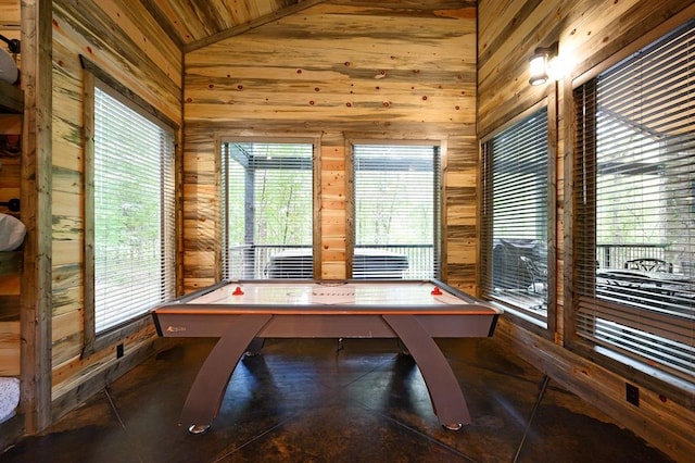 playroom featuring vaulted ceiling, wood ceiling, and wood walls