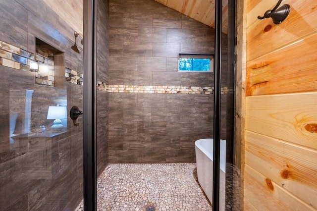 bathroom featuring separate shower and tub and vaulted ceiling