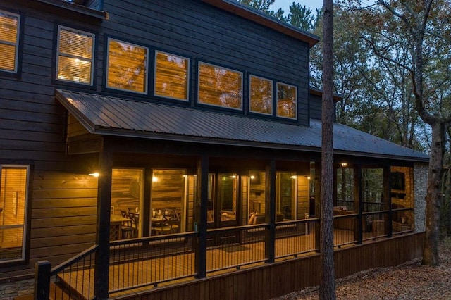 rear view of property with a sunroom