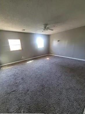 spare room featuring carpet flooring and ceiling fan