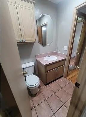 bathroom with tile patterned floors, vanity, and toilet