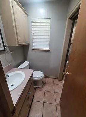 bathroom featuring tile patterned floors, vanity, and toilet