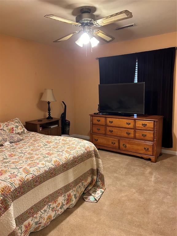 bedroom with light colored carpet and ceiling fan