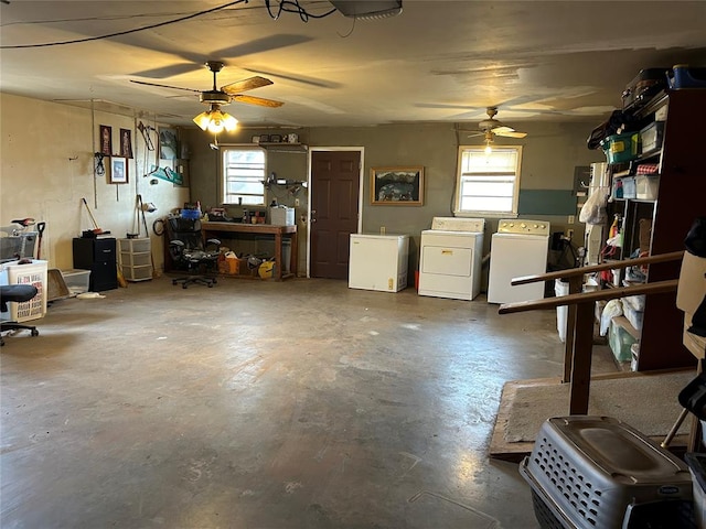 garage featuring a workshop area, ceiling fan, white fridge, and separate washer and dryer