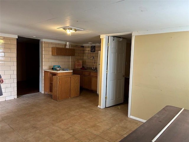 kitchen with tasteful backsplash and light tile patterned flooring