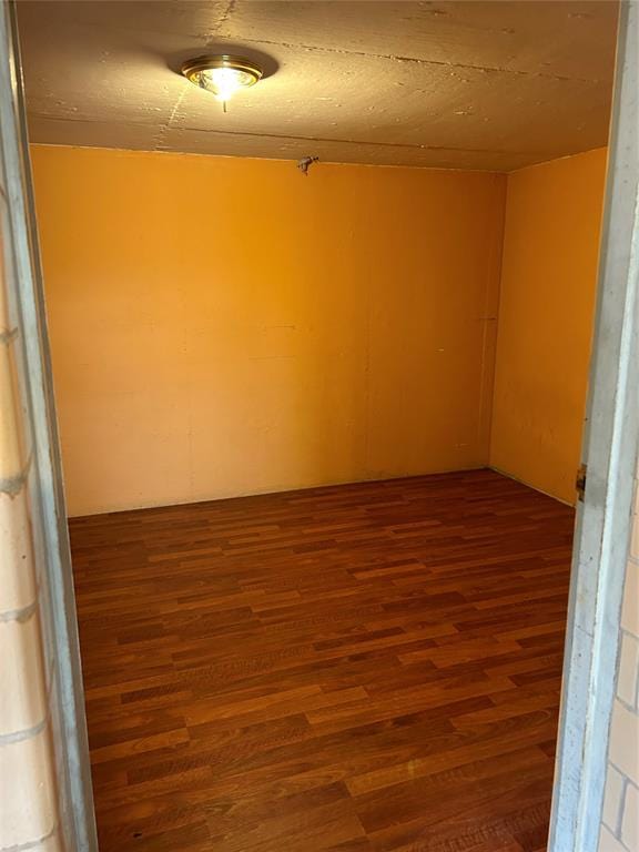 spare room with dark hardwood / wood-style floors