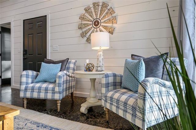 living area with wooden walls