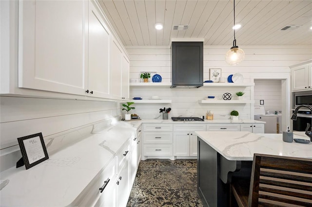 kitchen featuring pendant lighting, light stone countertops, white cabinetry, stainless steel appliances, and extractor fan