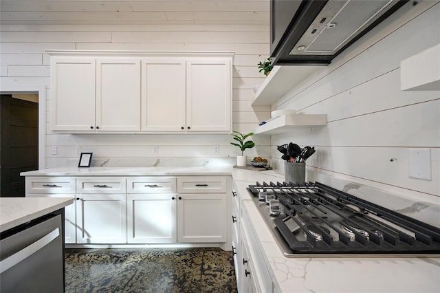 kitchen featuring black gas cooktop, white cabinetry, light stone counters, and ventilation hood