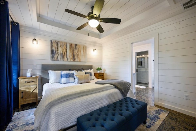 bedroom with ceiling fan and wooden walls