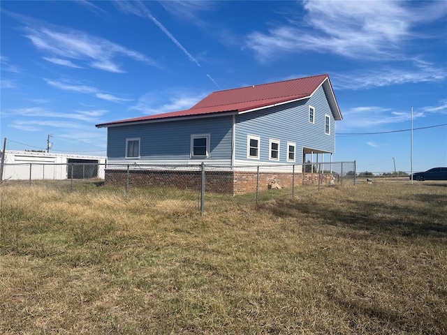 view of side of home featuring a yard