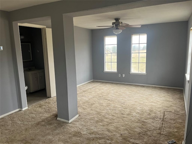 carpeted spare room with ceiling fan