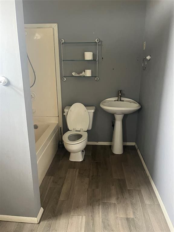 bathroom featuring hardwood / wood-style floors and toilet