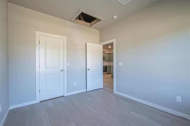 unfurnished bedroom featuring hardwood / wood-style flooring