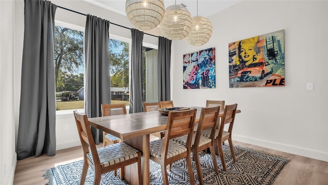 dining area with light hardwood / wood-style floors and a wealth of natural light