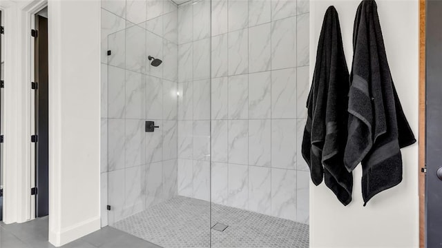 bathroom featuring tile patterned floors and tiled shower