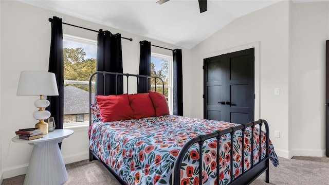 bedroom with multiple windows, ceiling fan, light colored carpet, and lofted ceiling