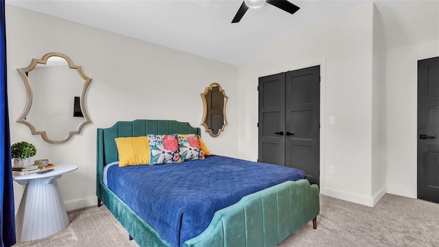 carpeted bedroom featuring ceiling fan and a closet