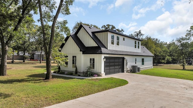 modern farmhouse style home with central air condition unit, a front yard, and a garage