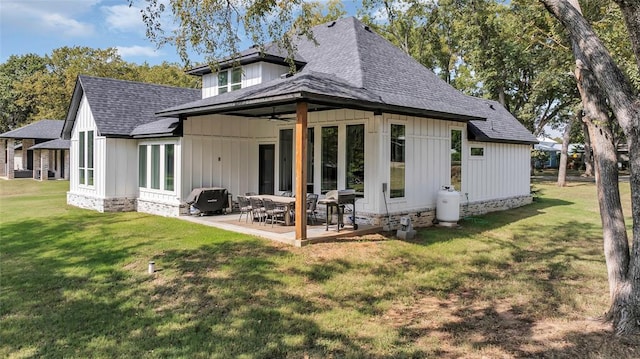 rear view of property featuring a patio area and a yard