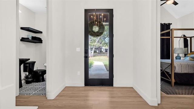 entrance foyer with light hardwood / wood-style flooring, ceiling fan, and lofted ceiling