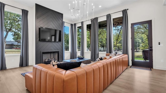 living room featuring a fireplace, plenty of natural light, and light hardwood / wood-style floors